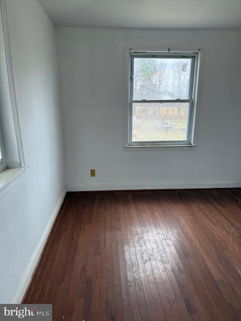 21365 Canoe Neck Way Abell, MD 20606 - Photo 3 of 23 an empty room with wooden floor and windows