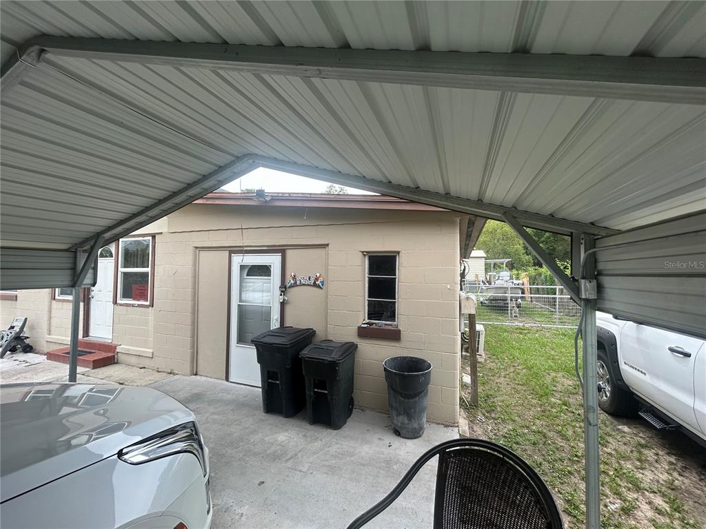 18133 Highway 41 Spring Hill, FL 34610 - Photo 15 of 18 a backyard of a house with outdoor seating