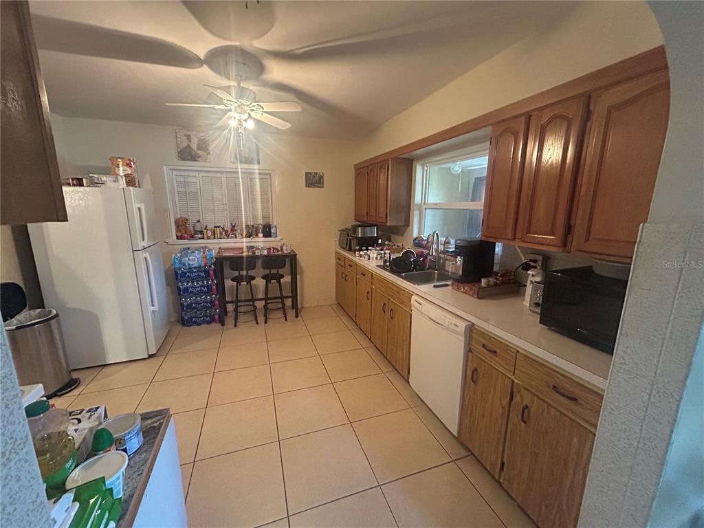 18133 Highway 41 Spring Hill, FL 34610 - Photo 6 of 18 a kitchen with stainless steel appliances a sink a stove a refrigerator and cabinets