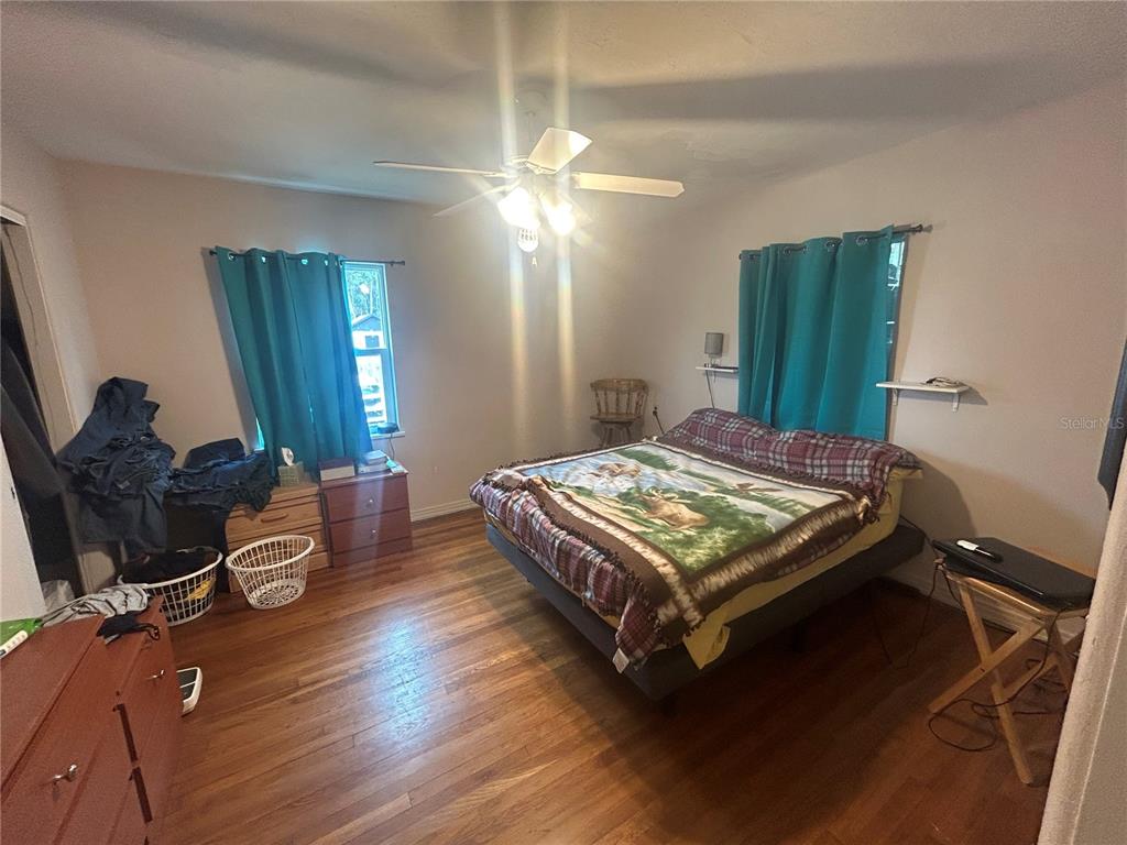 18133 Highway 41 Spring Hill, FL 34610 - Photo 10 of 18 a bedroom with a bed and wooden floor