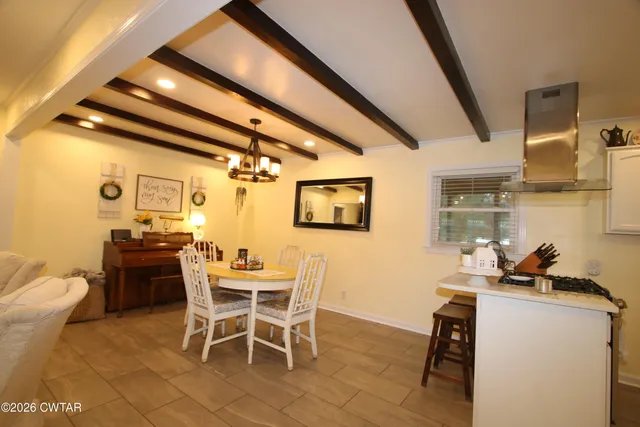 a dining room with furniture and a window
