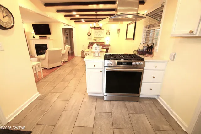 a kitchen with stainless steel appliances granite countertop a stove and a refrigerator