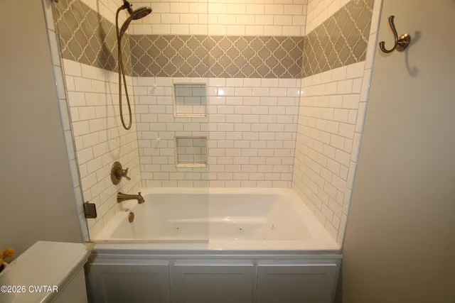 a bathroom with a bathtub and shower