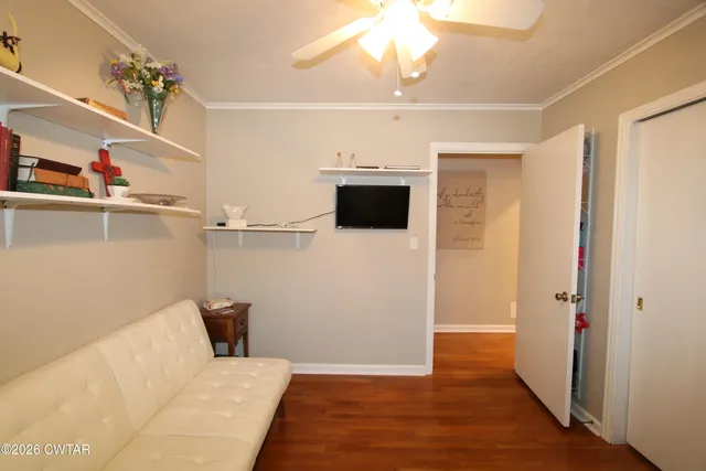 a view of a room with wooden floor