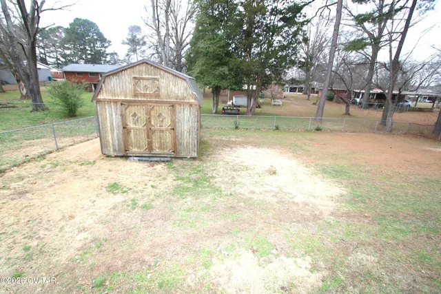 a view of a large garden with large trees