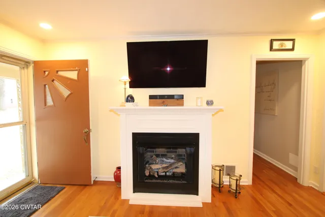 a living room with a fireplace and a flat screen tv