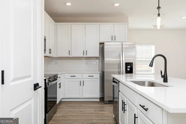 a kitchen with a sink stainless steel appliances and cabinets