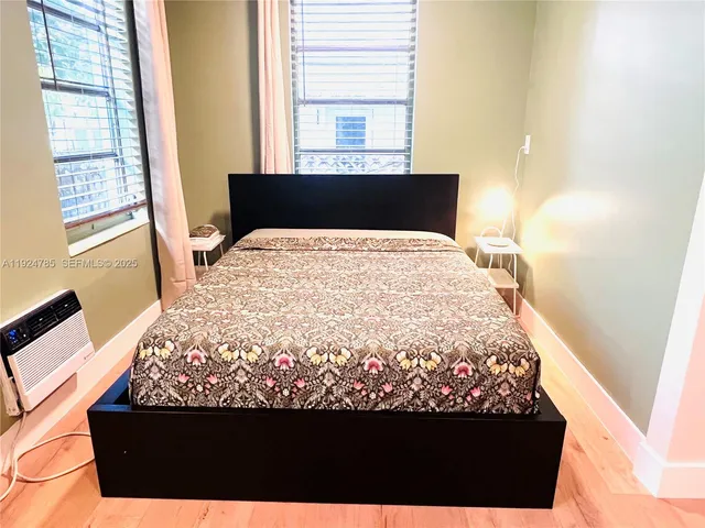 a bed sitting in a bedroom next to a window