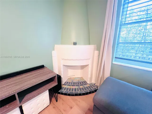 a backyard of a house with barbeque oven table and chairs