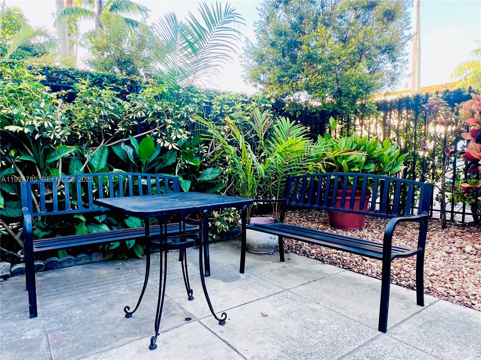 1525 Meridian Avenue, Unit 110 Miami Beach, FL 33139 - Photo 17 of 23 a backyard of a house with barbeque oven table and chairs