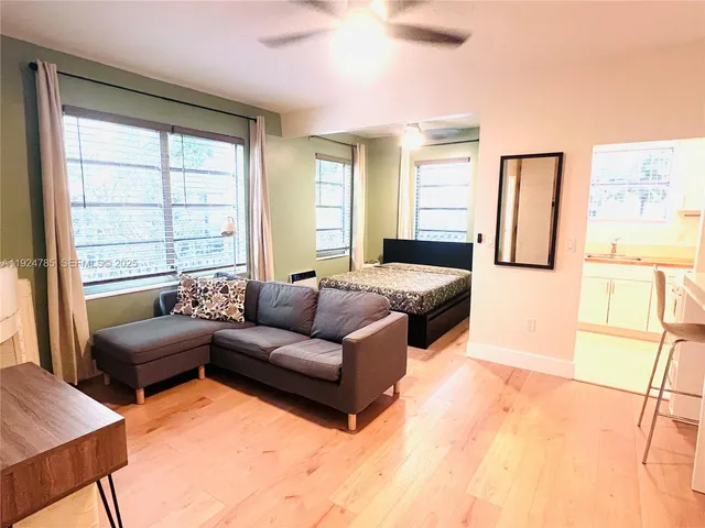 a bedroom with furniture and a large window