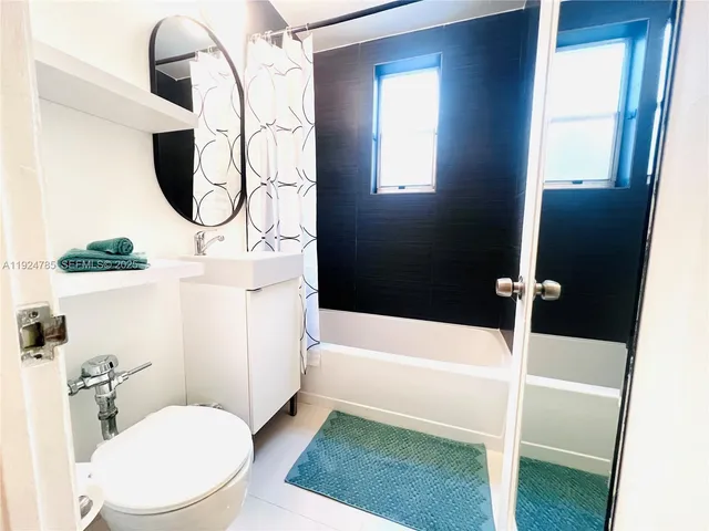 a bathroom with a sink a toilet and bathtub