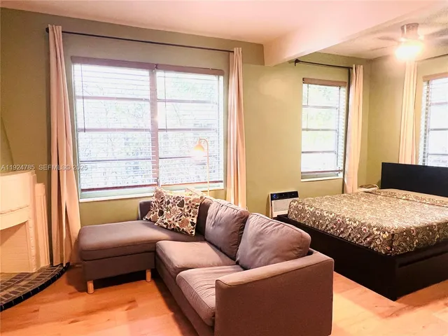 a bedroom with bed couch and window