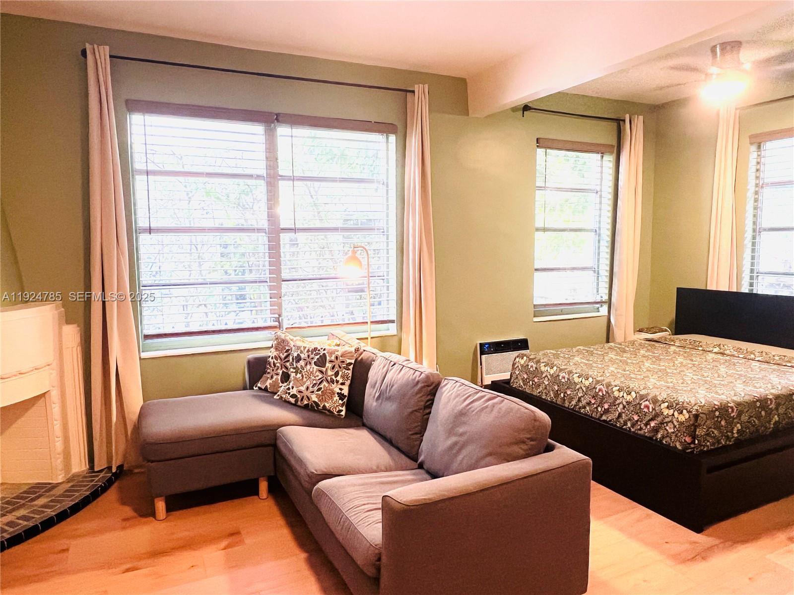 1525 Meridian Avenue, Unit 110 Miami Beach, FL 33139 - Photo 7 of 23 a bedroom with bed couch and window