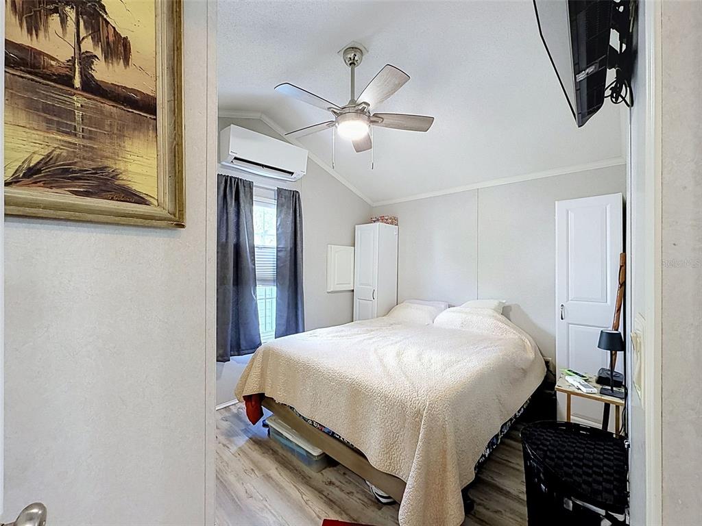 2092 Culbreath Road, Unit A42 Brooksville, FL 34602 - Photo 63 of 70 a bedroom with a bed and a chandelier