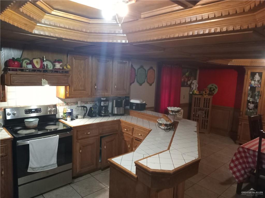 5614 Acapulco Street Rio Grande City, TX 78582 - Photo 10 of 11 a kitchen with a sink a stove and cabinets