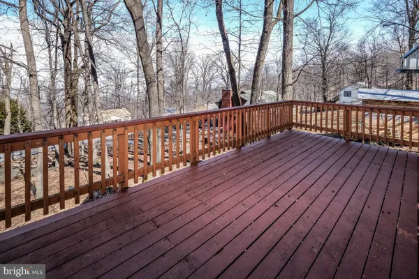 a room with chandelier fan and windows