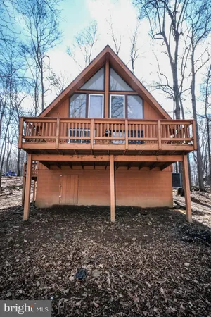 a view of a house with a yard covered in snow