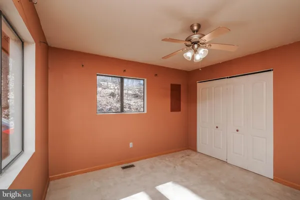 a view of a lake with a bench and a yard