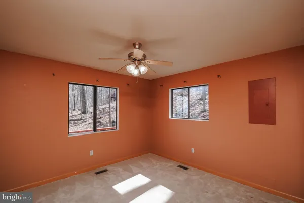 a front view of a house with a yard and potted plants