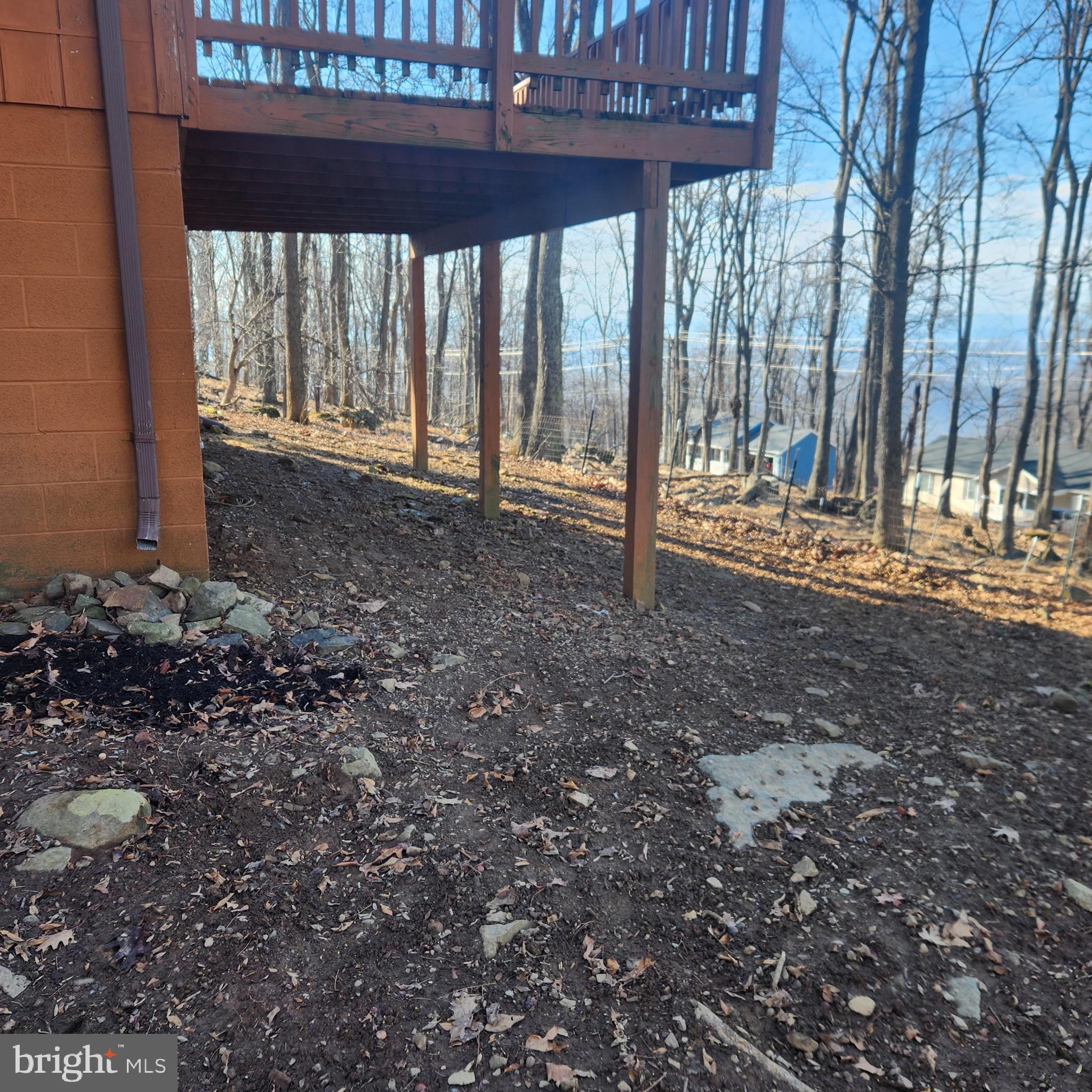 59 Alpine Drive Front Royal, VA 22630 - Photo 58 of 82 a view of a backyard with large trees and wooden fence