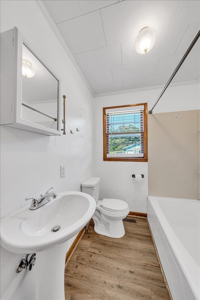 341 Rigsby Road Smithville, TN 37166 - Photo 13 of 34 a bathroom with a sink toilet a mirror and bathtub