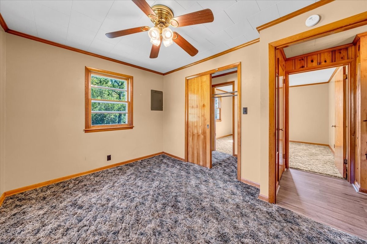 341 Rigsby Road Smithville, TN 37166 - Photo 15 of 34 a view of an empty room with wooden floor and a ceiling fan
