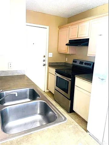 a view of a kitchen with a sink and dishwasher
