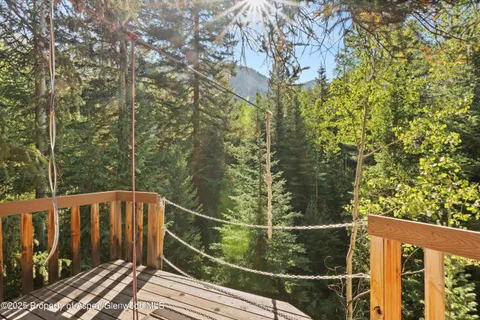 a view of balcony with wooden floor and fence