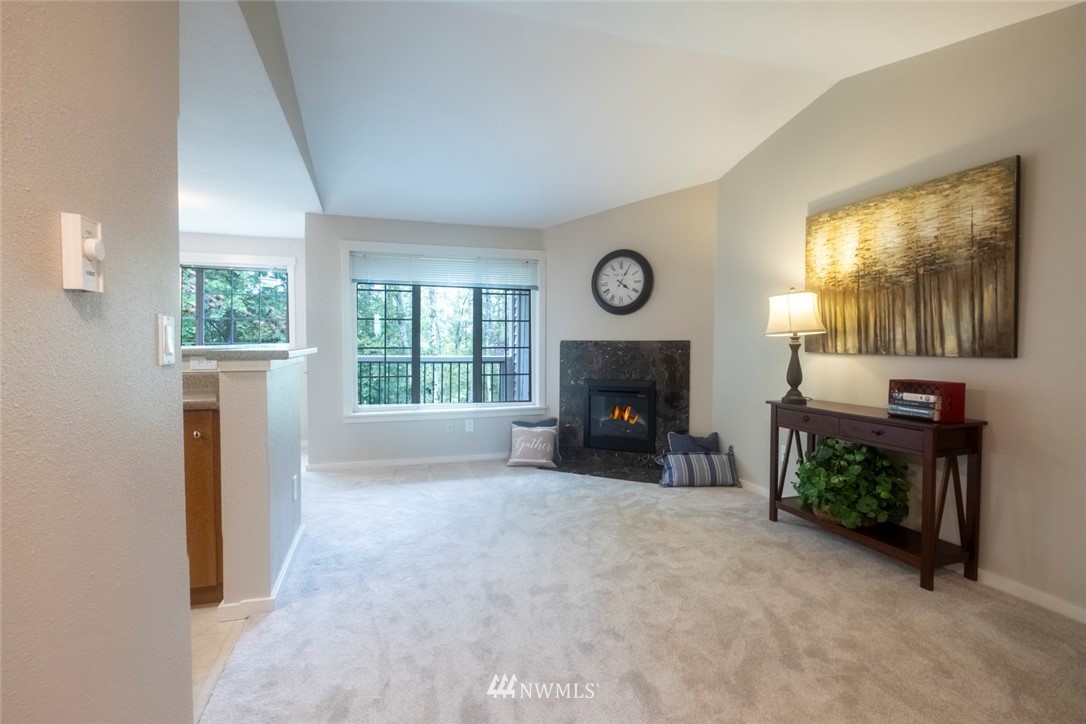 12404 East Gibson Road, Unit F303 Everett, WA 98204 - Photo 2 of 23 a living room with furniture and a fireplace