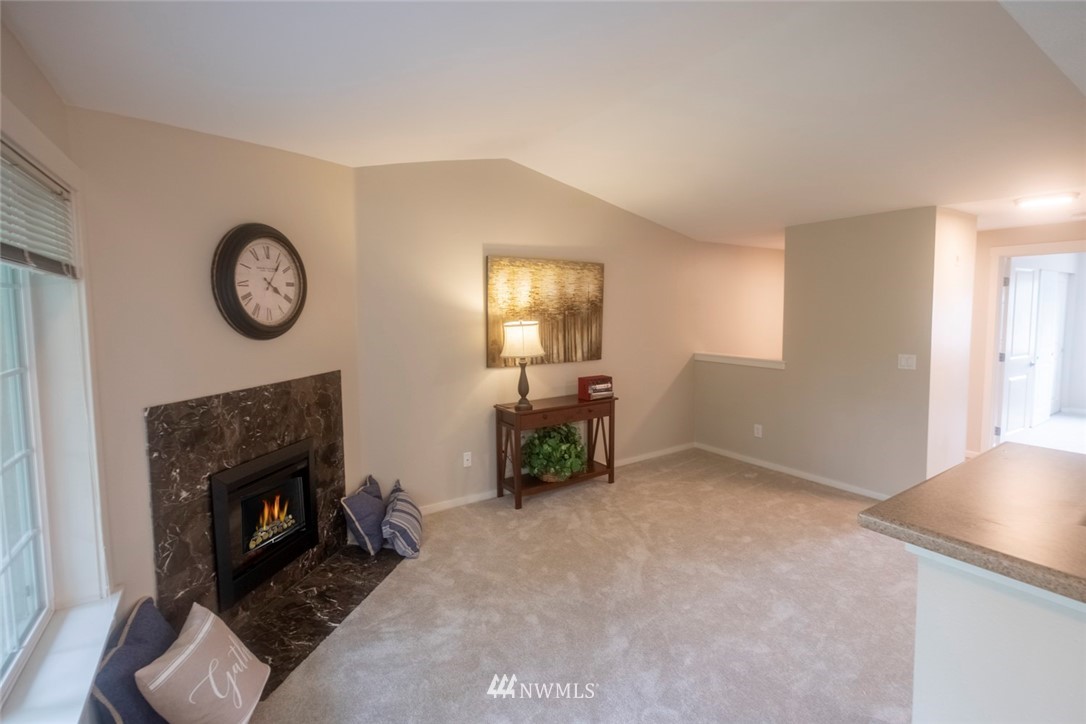 12404 East Gibson Road, Unit F303 Everett, WA 98204 - Photo 11 of 23 a view of livingroom with furniture fireplace and window
