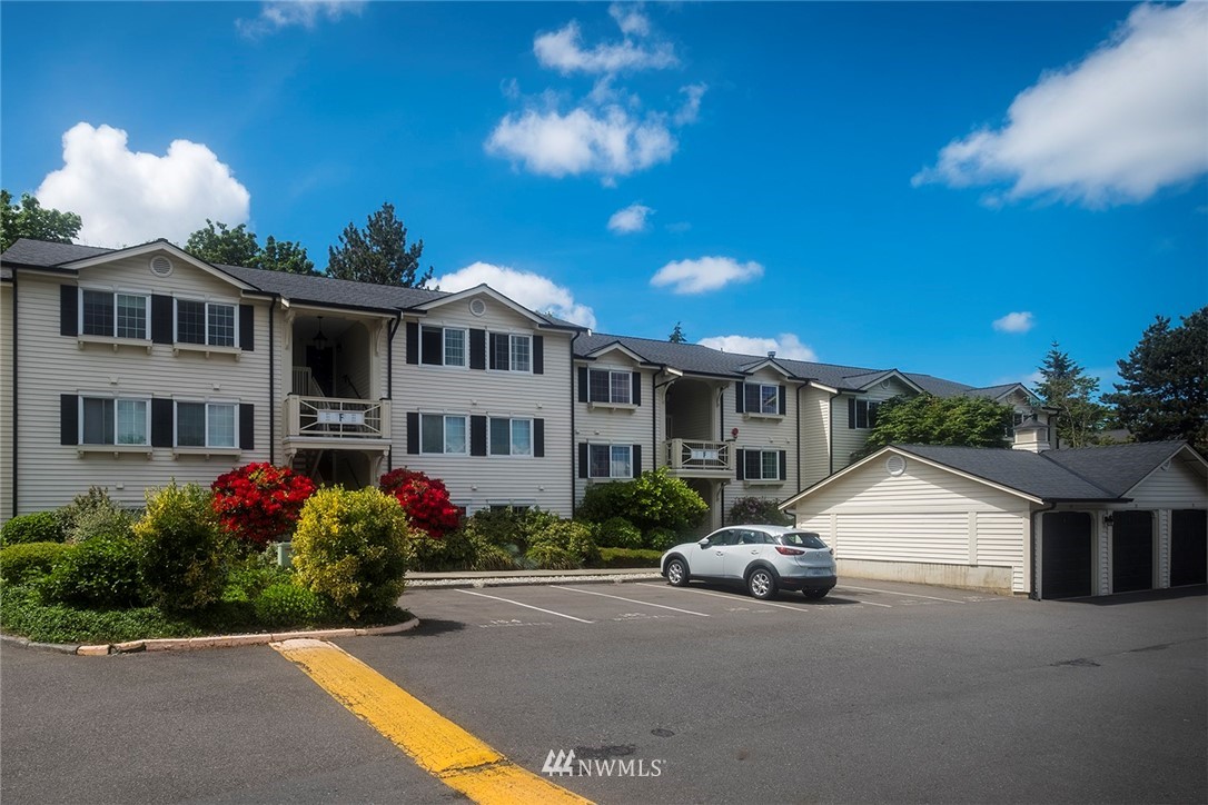 12404 East Gibson Road, Unit F303 Everett, WA 98204 - Photo 23 of 23 a front view of a house with a yard and a garage