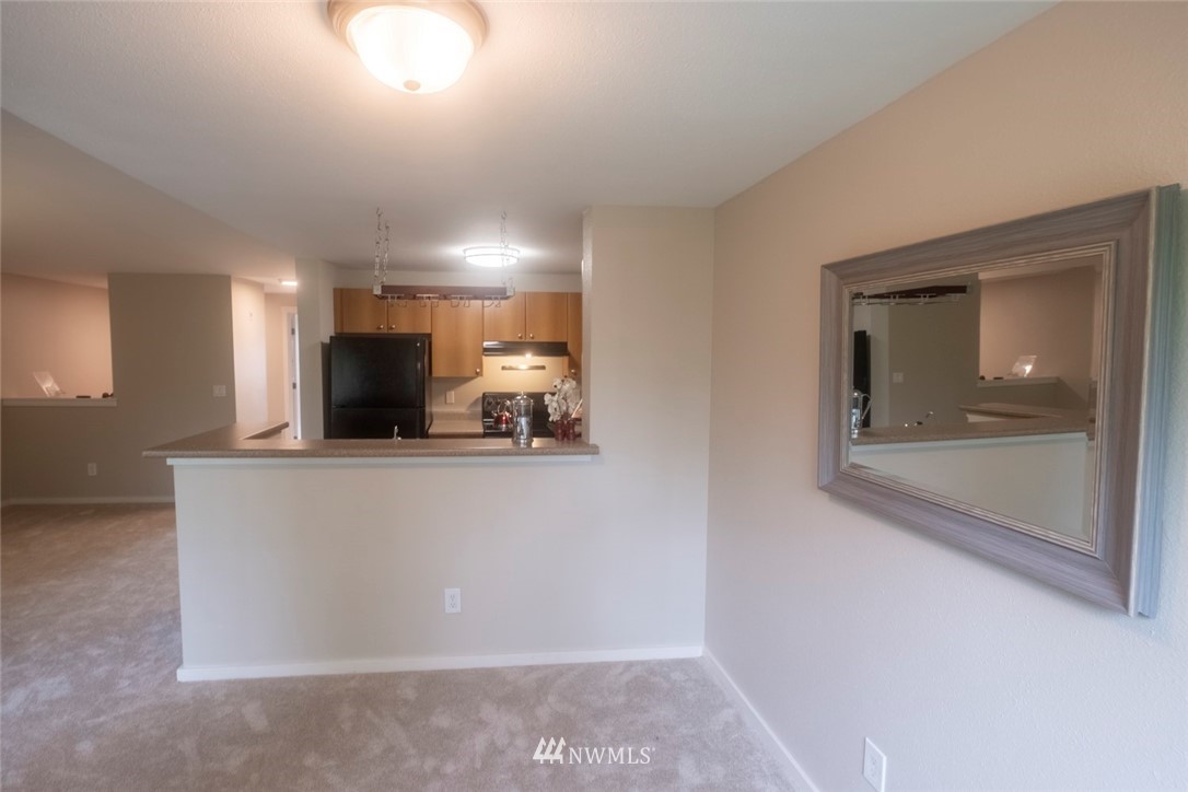 12404 East Gibson Road, Unit F303 Everett, WA 98204 - Photo 5 of 23 a view of kitchen with two windows and a refrigerator