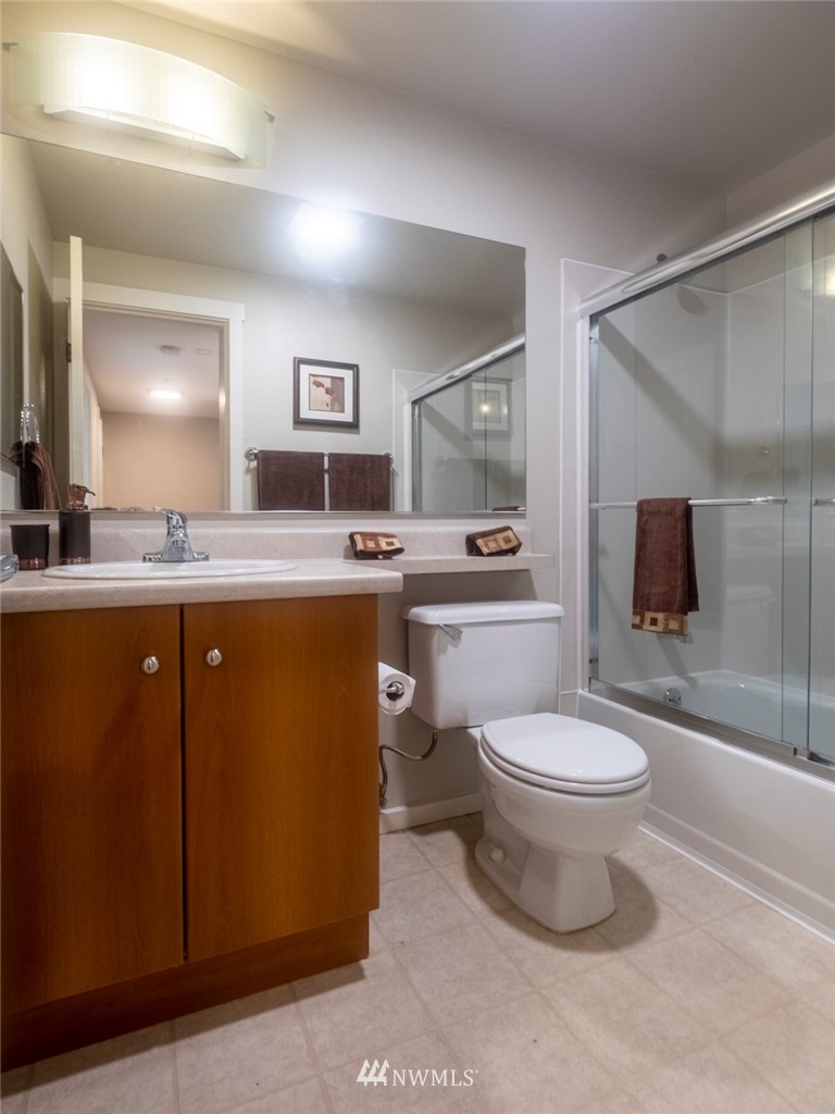 12404 East Gibson Road, Unit F303 Everett, WA 98204 - Photo 7 of 23 a room with stainless steel appliances a sink a window and a mirror