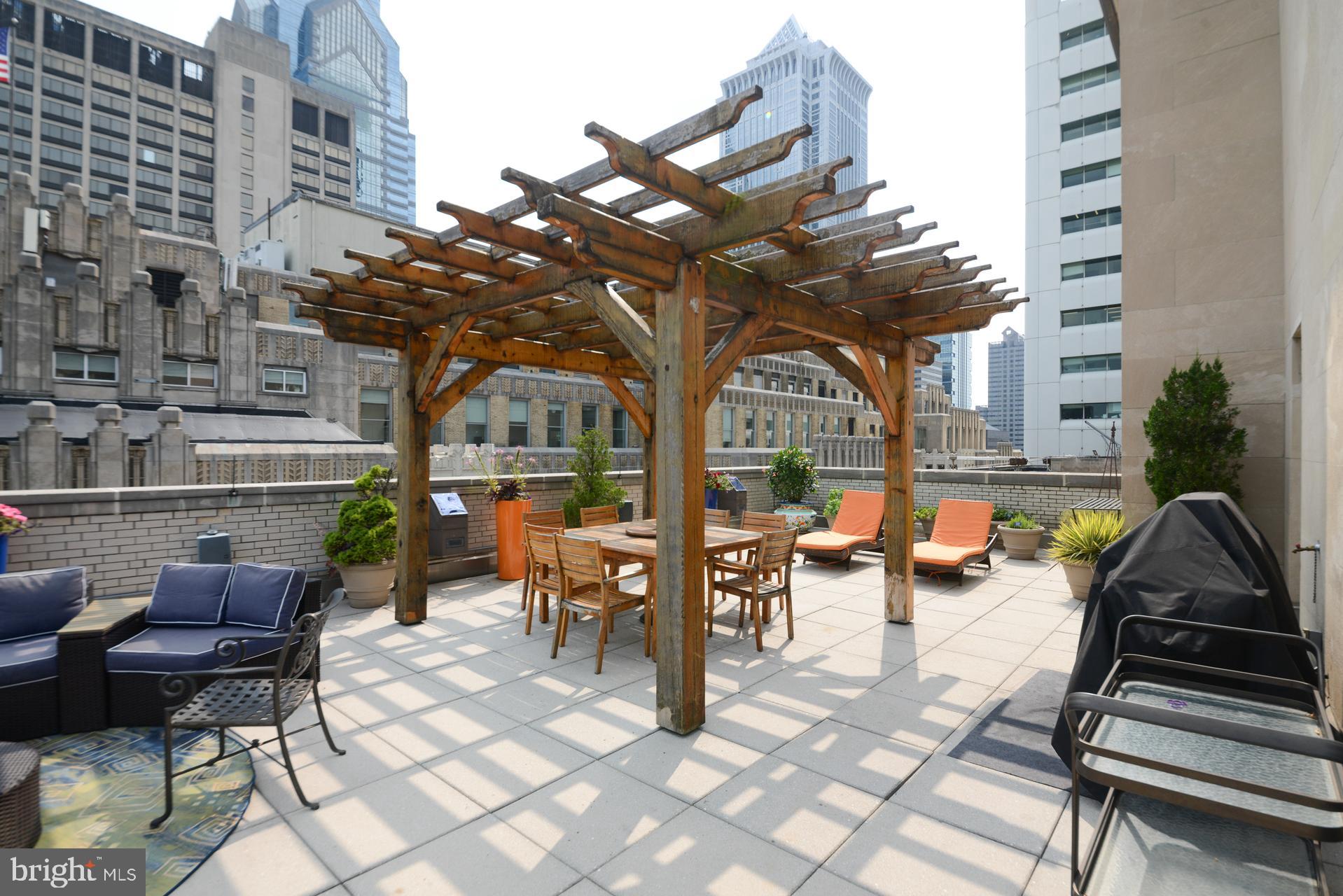 1600-18 Arch Street, Unit 1410 Philadelphia, PA 19103 - Photo 18 of 25 a view of a patio with couches table and chairs and potted plants