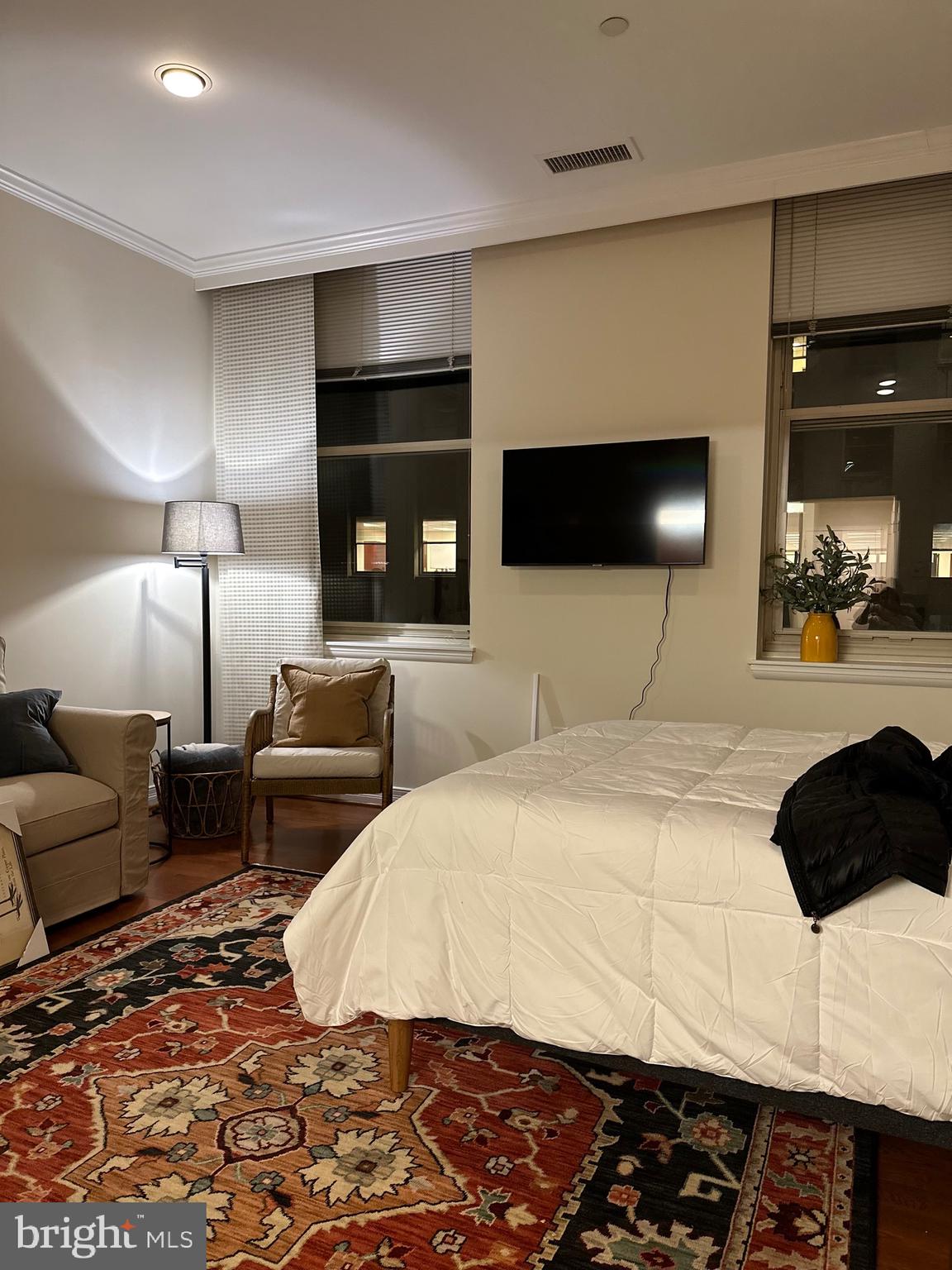 1600-18 Arch Street, Unit 1410 Philadelphia, PA 19103 - Photo 2 of 25 a bedroom with a bed a couch and a flat screen tv