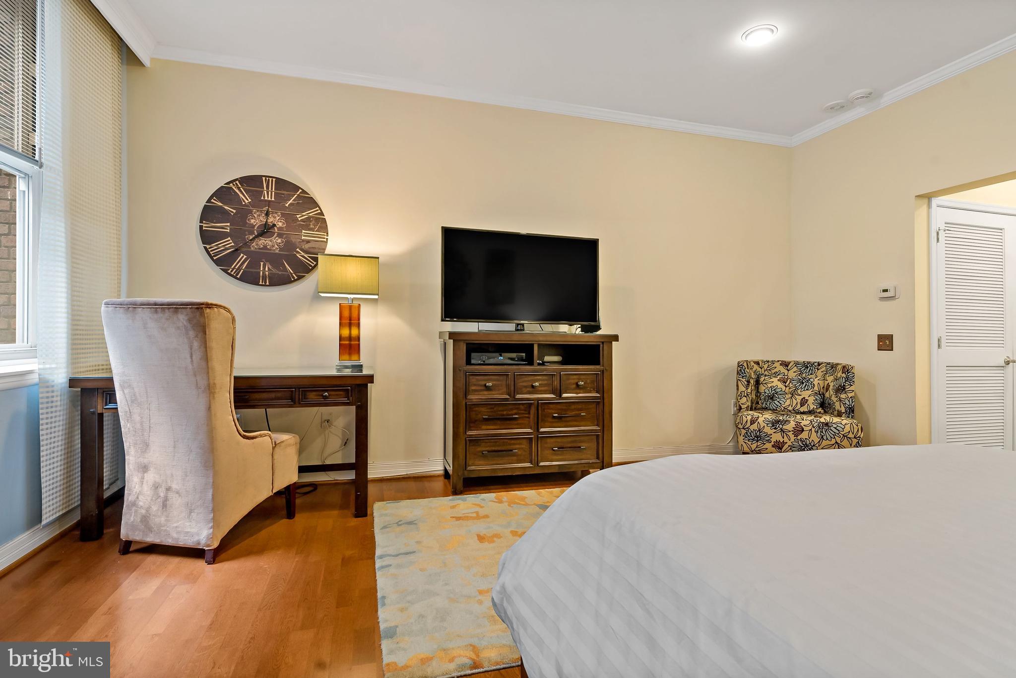 1600-18 Arch Street, Unit 1410 Philadelphia, PA 19103 - Photo 3 of 25 a bedroom with a bed and a television in it