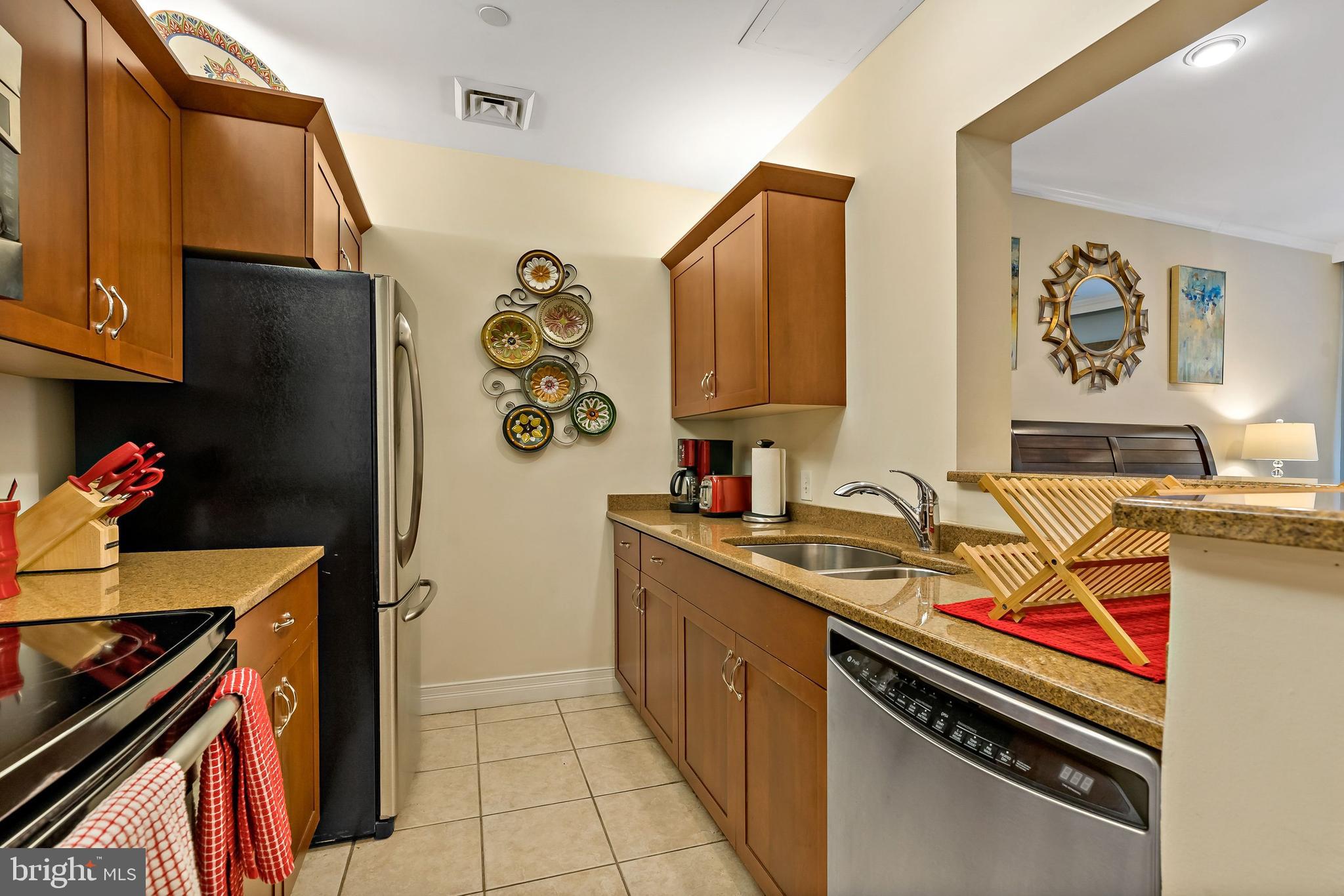 1600-18 Arch Street, Unit 1410 Philadelphia, PA 19103 - Photo 5 of 25 a kitchen with stainless steel appliances granite countertop a sink stove and refrigerator