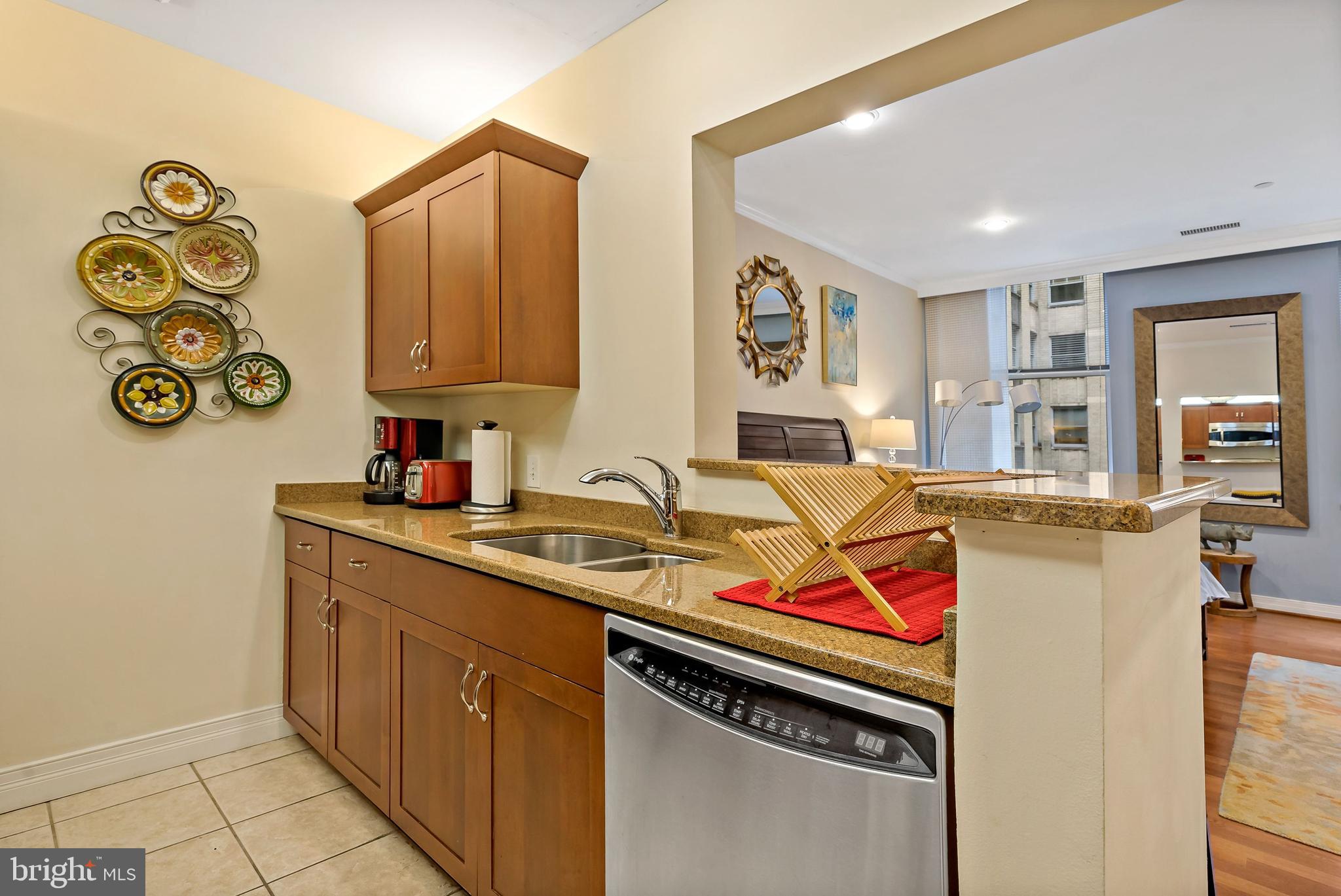 1600-18 Arch Street, Unit 1410 Philadelphia, PA 19103 - Photo 6 of 25 a utility room with stainless steel appliances granite countertop a sink and cabinets