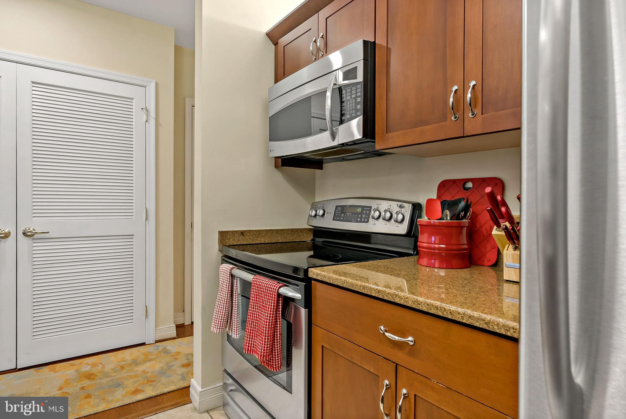 1600-18 Arch Street, Unit 1410 Philadelphia, PA 19103 - Photo 8 of 25 a kitchen with stainless steel appliances granite countertop a stove and a microwave