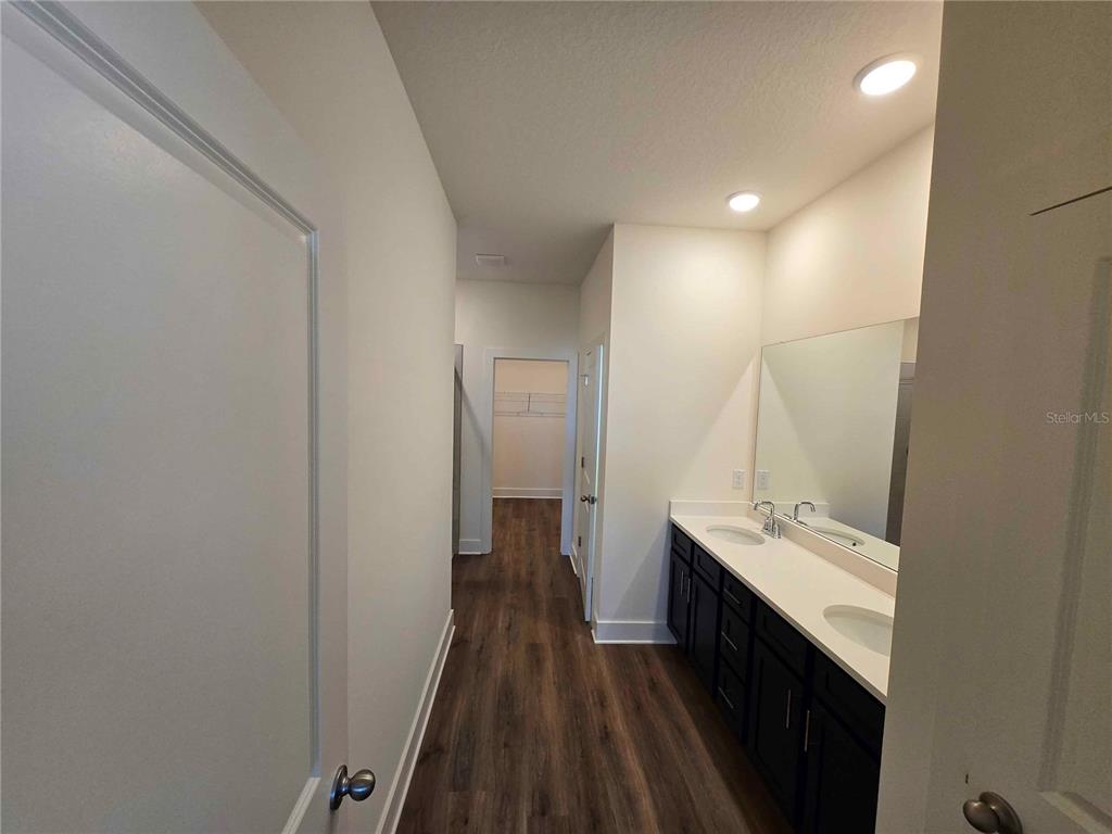 3819 Daybreak Run Loop Spring Hill, FL 34609 - Photo 8 of 15 a bathroom with a double vanity sink and mirror