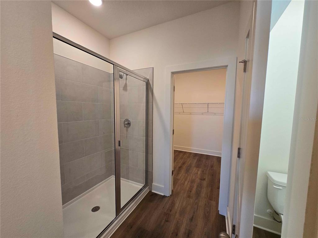 3819 Daybreak Run Loop Spring Hill, FL 34609 - Photo 9 of 15 a bathroom with a glass shower door