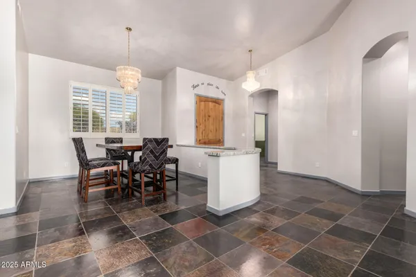 a view of a dining room with furniture wooden floor and chandelier