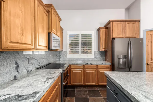 a kitchen with stainless steel appliances granite countertop a sink and cabinets