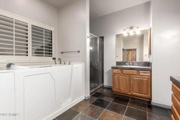 a spacious bathroom with a sink double vanity and a mirror
