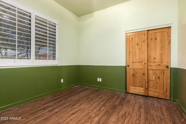 a view of a room with wooden floor and cabinet