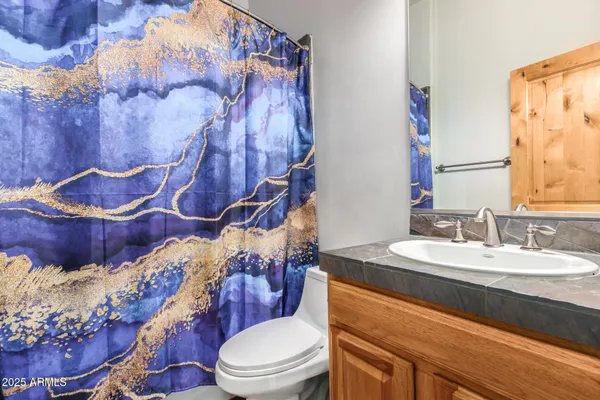 a bedroom with a bed and a painting on the wall