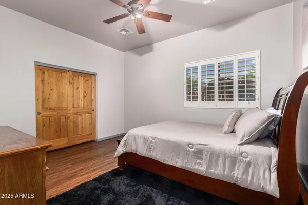 a large bed sitting in a bedroom next to a window and outside bathroom