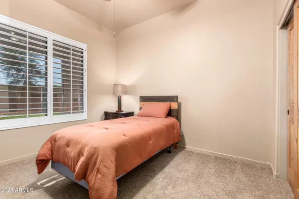 an empty room with wooden floor and closet