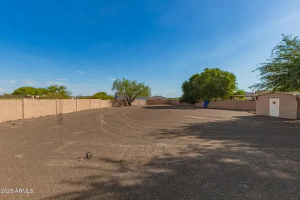 a view of a house with a yard and potted plants